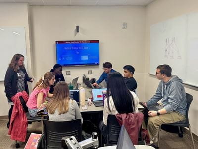 A group of medical students and a faculty member engage in a small group session