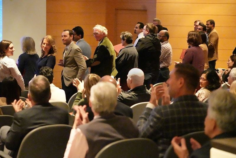 Trustees Teaching Award winners stand and receive applause at the Spring 2025 All School Meeting.