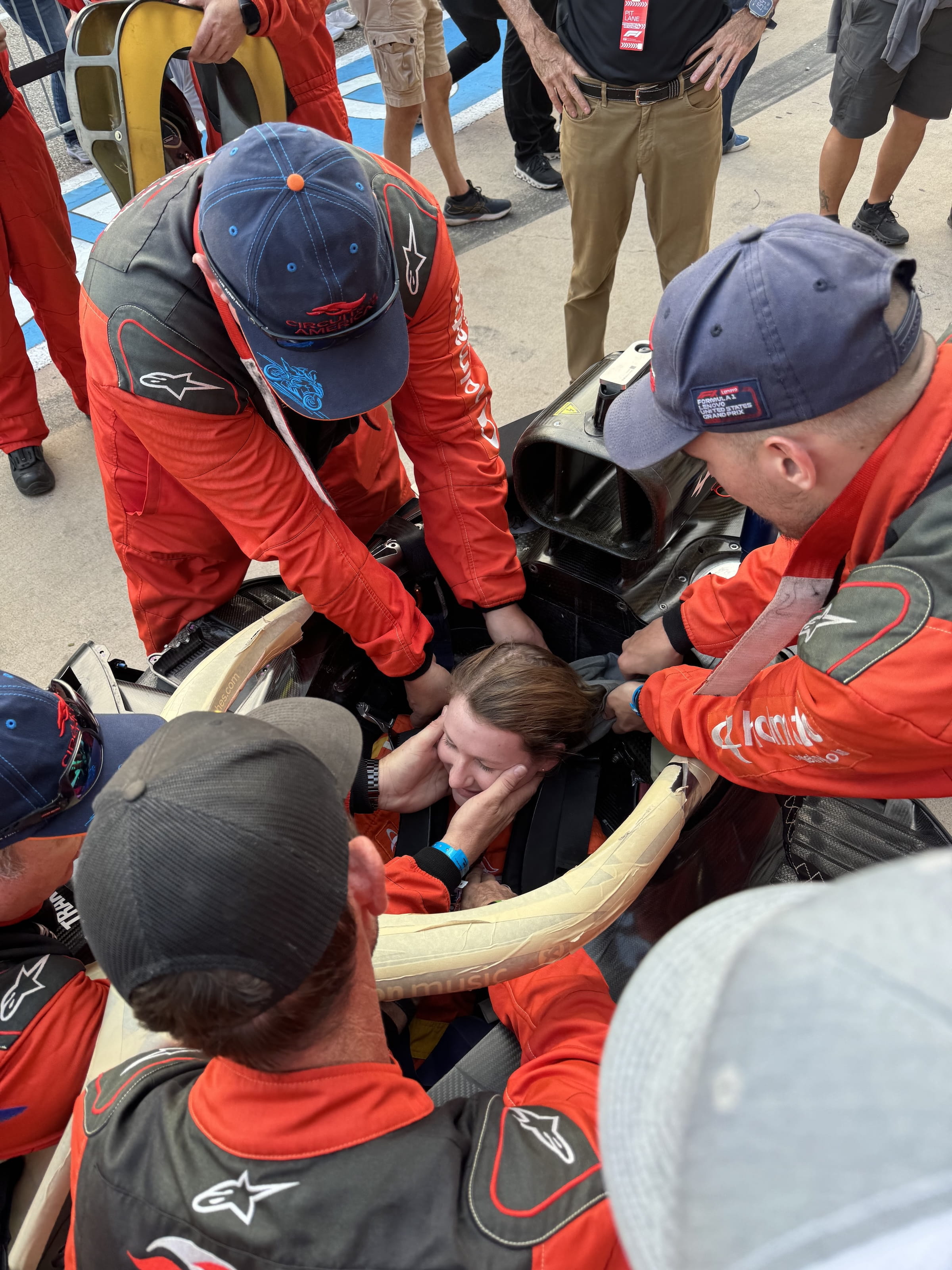 Liz Sullivan sits in as a driver during a Safety Team drill to practice extrication from a Formula One car.