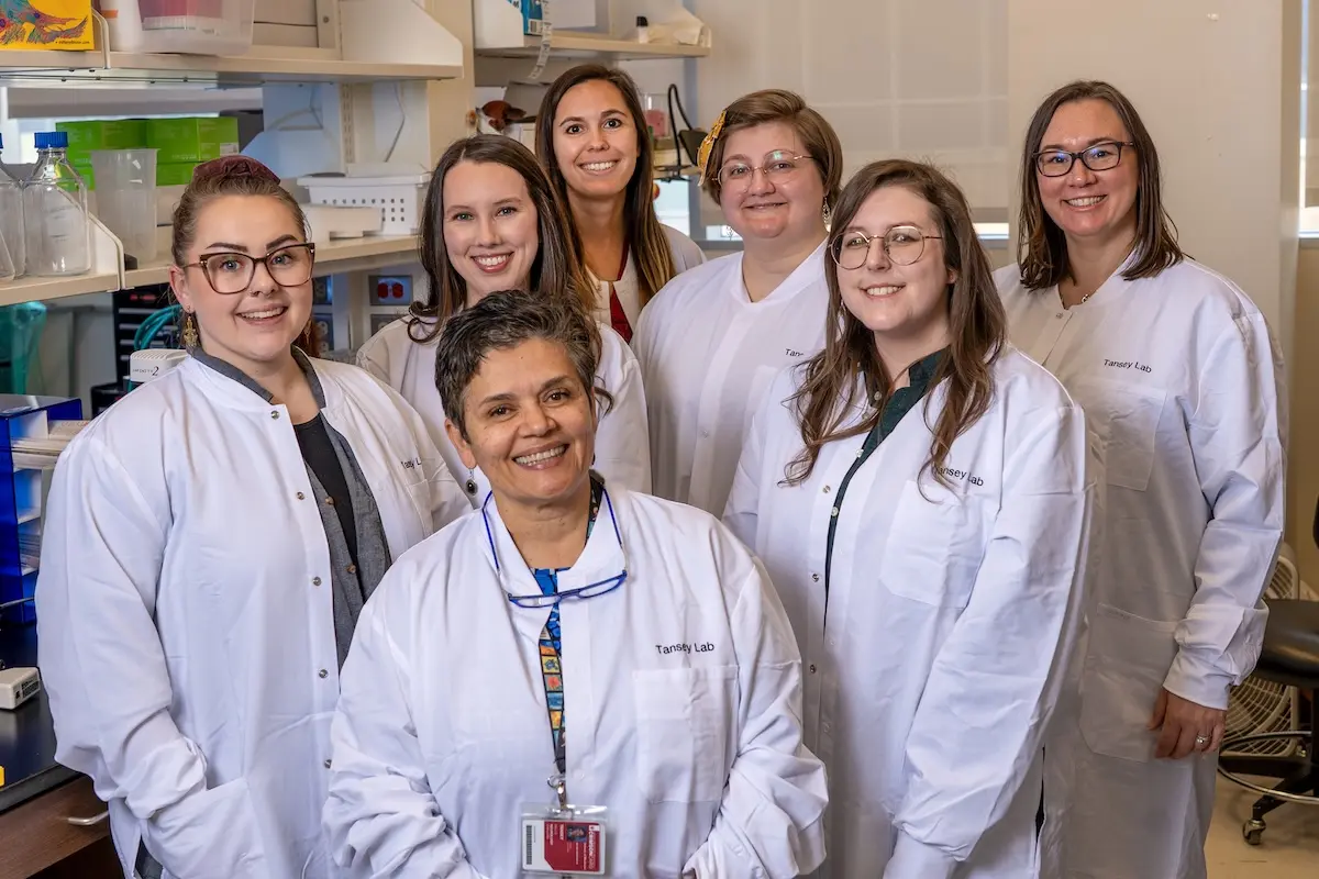 Malu Tansey is surrounded by the all-female members of her laboratory at IU School of Medicine.