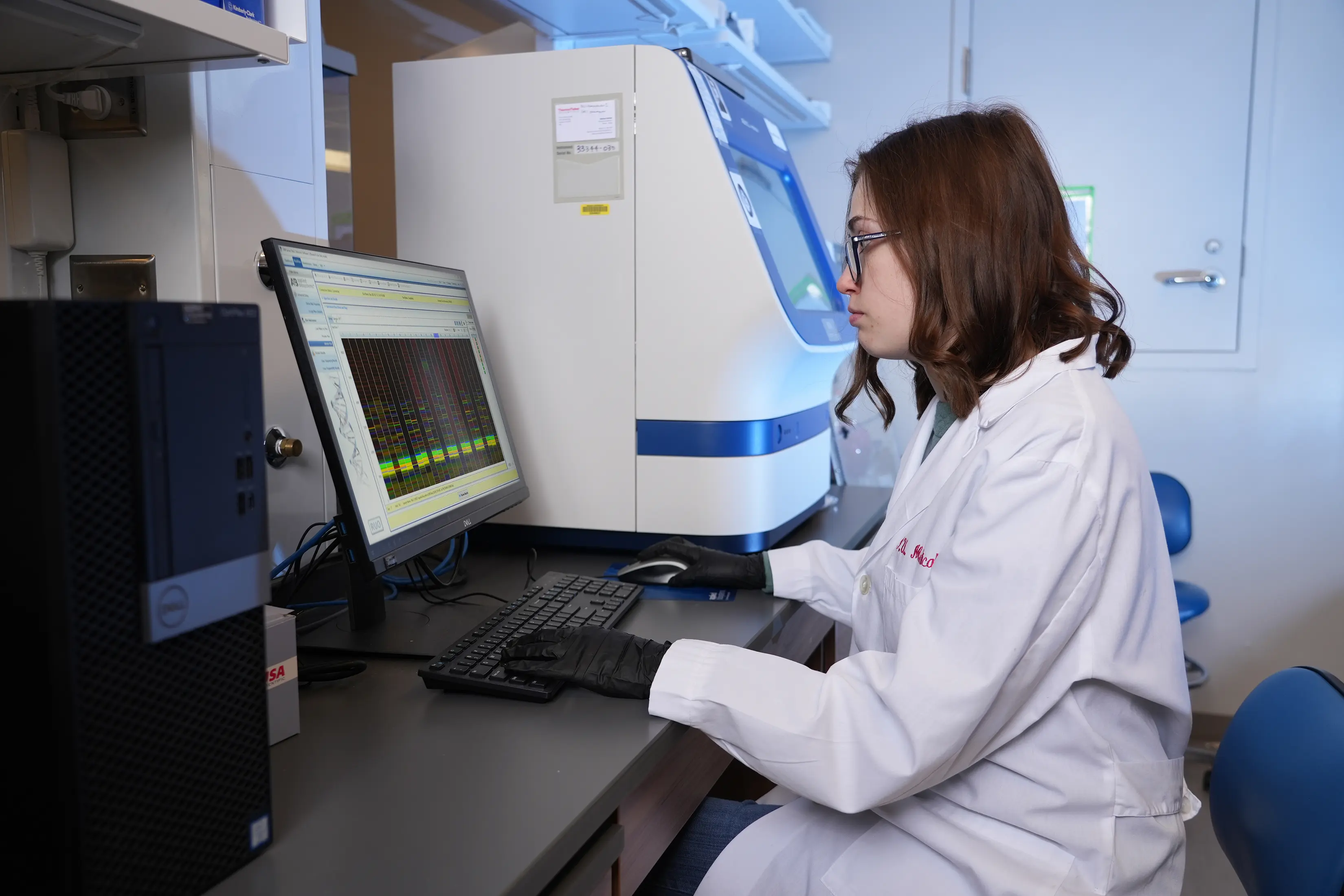 researcher sitting at computer in lab 