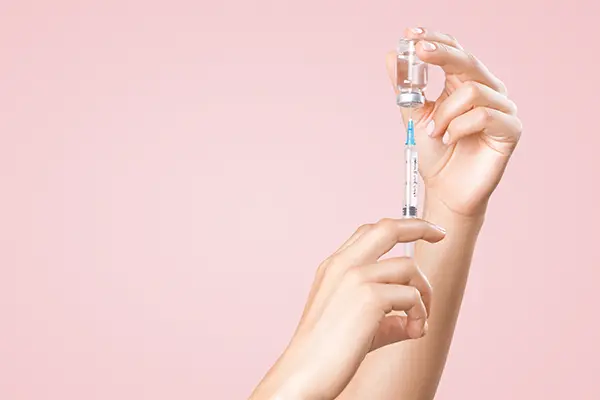 A vaccination syringe getting prepared.