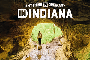 A person leaves a cave and in text it says "Anything But Ordinary in Indiana."
