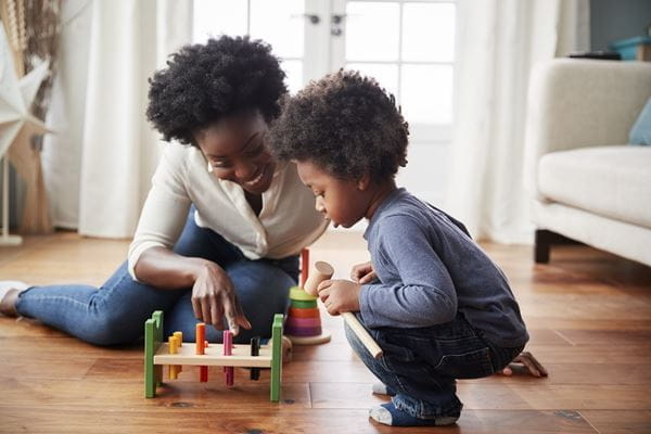 A mother and toddler play together
