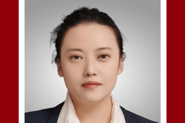 A headshot of Ying Wang, a woman with dark hair styled into a ponytail.