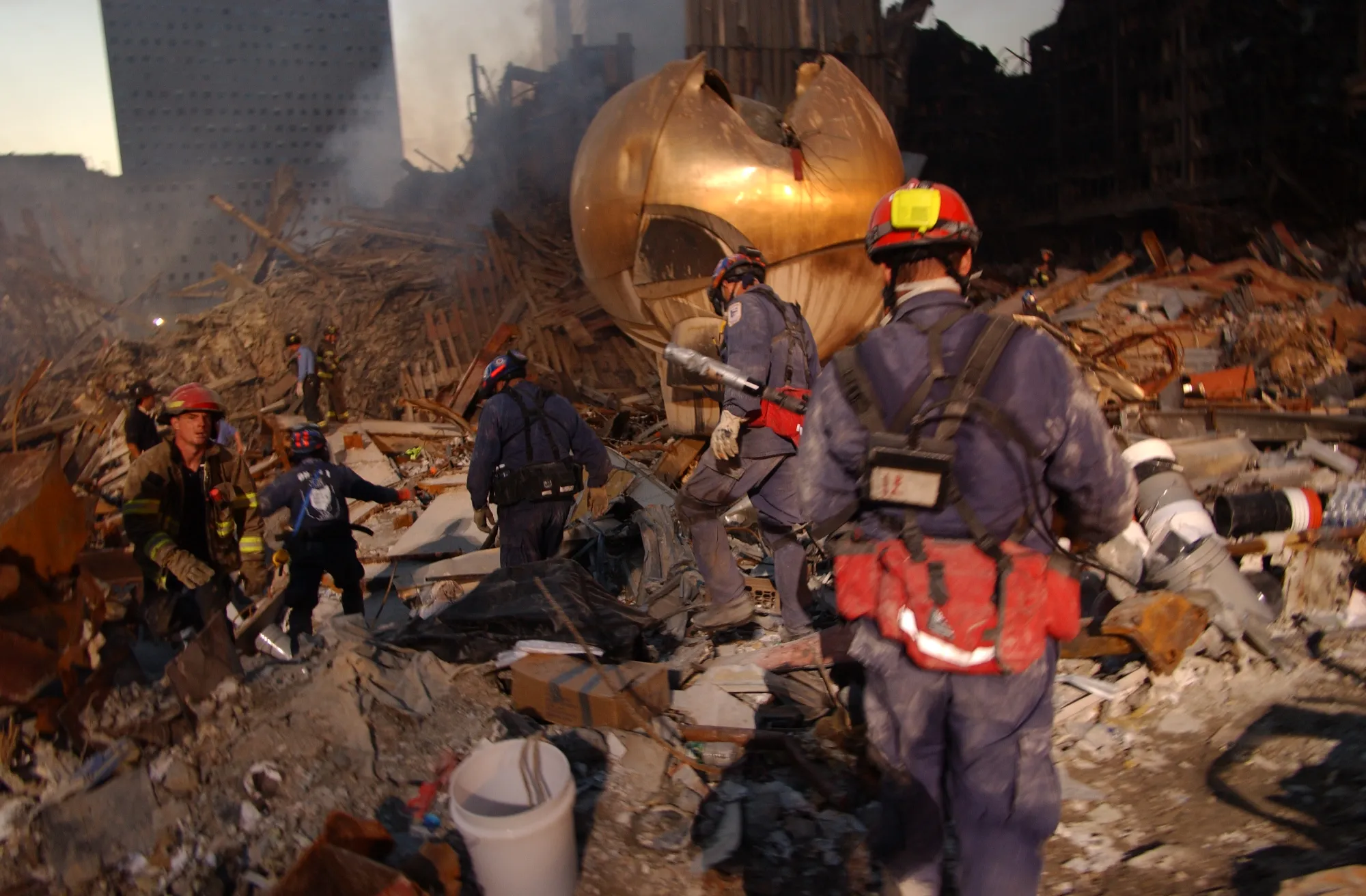 FEMA Search and Rescue workers sift through the rubble at Ground Zero at night.