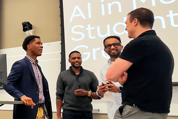 From left: SIG President Aaron Wills talks to Bralin Coleman, AJ Lahade and Brian Skertic.
