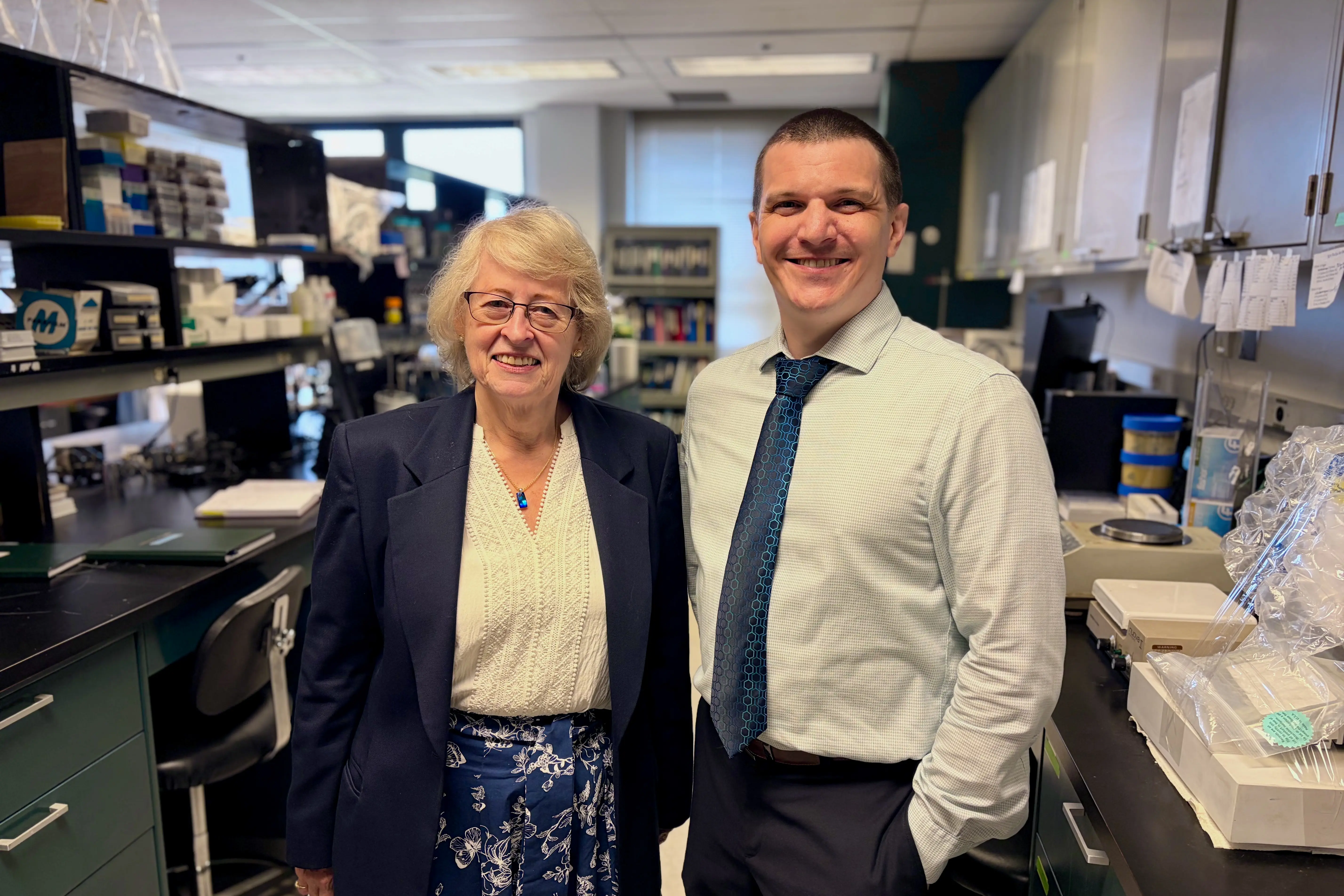 Bonnie Blazer-Yost and Kyle Gospodarek stand together in a lab at the Hydrocephalus Research Center.