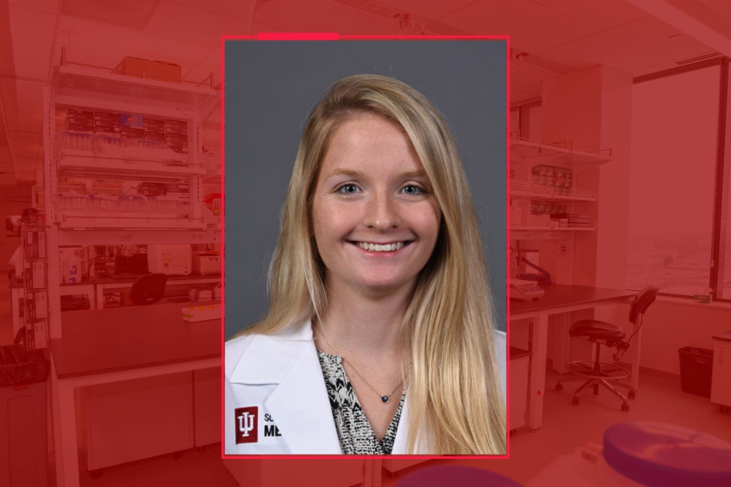 Headshot of Emily White wearing white lab coat on gray background