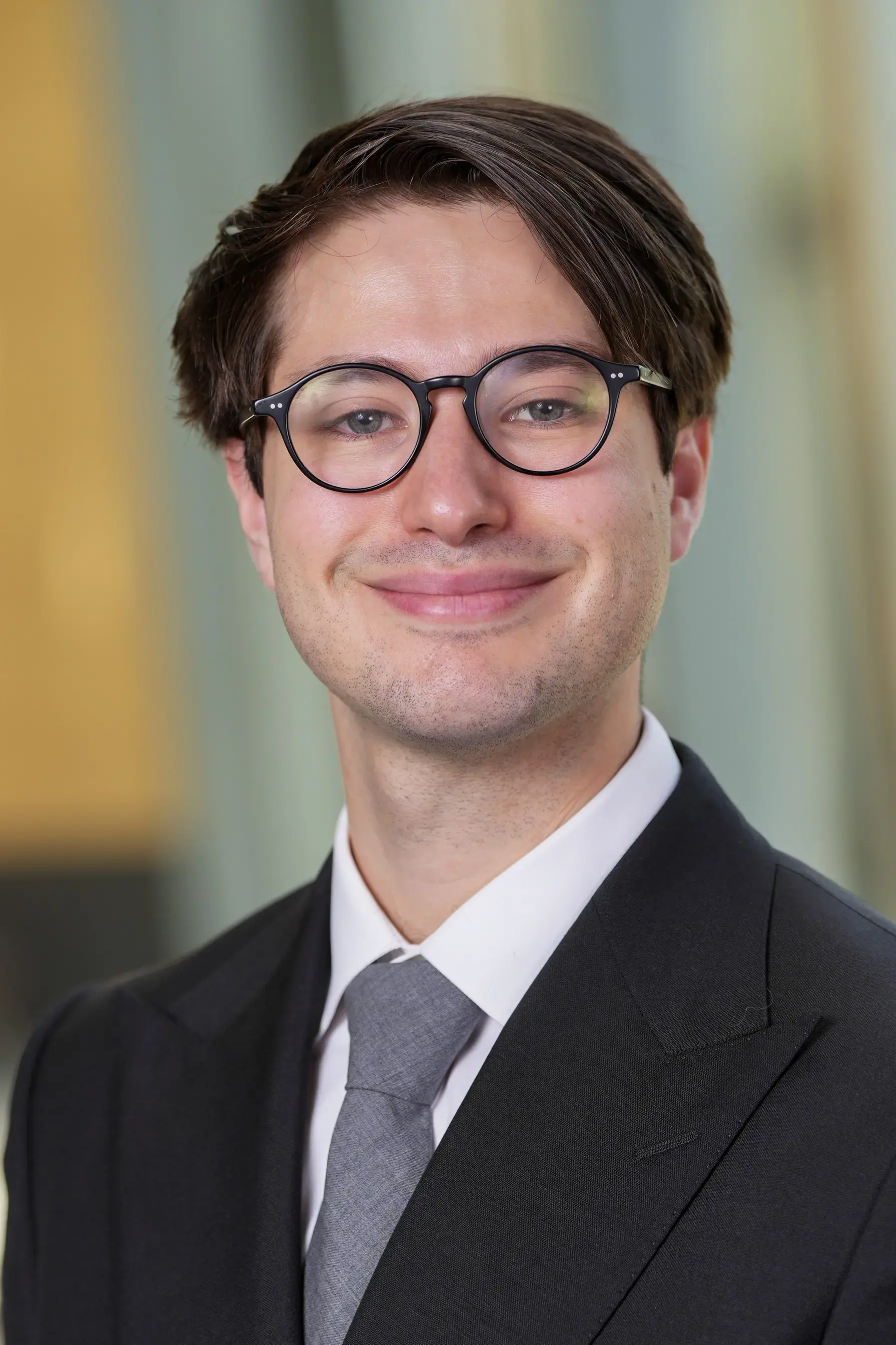 Person in professinal attire in front of blurred office lobby background