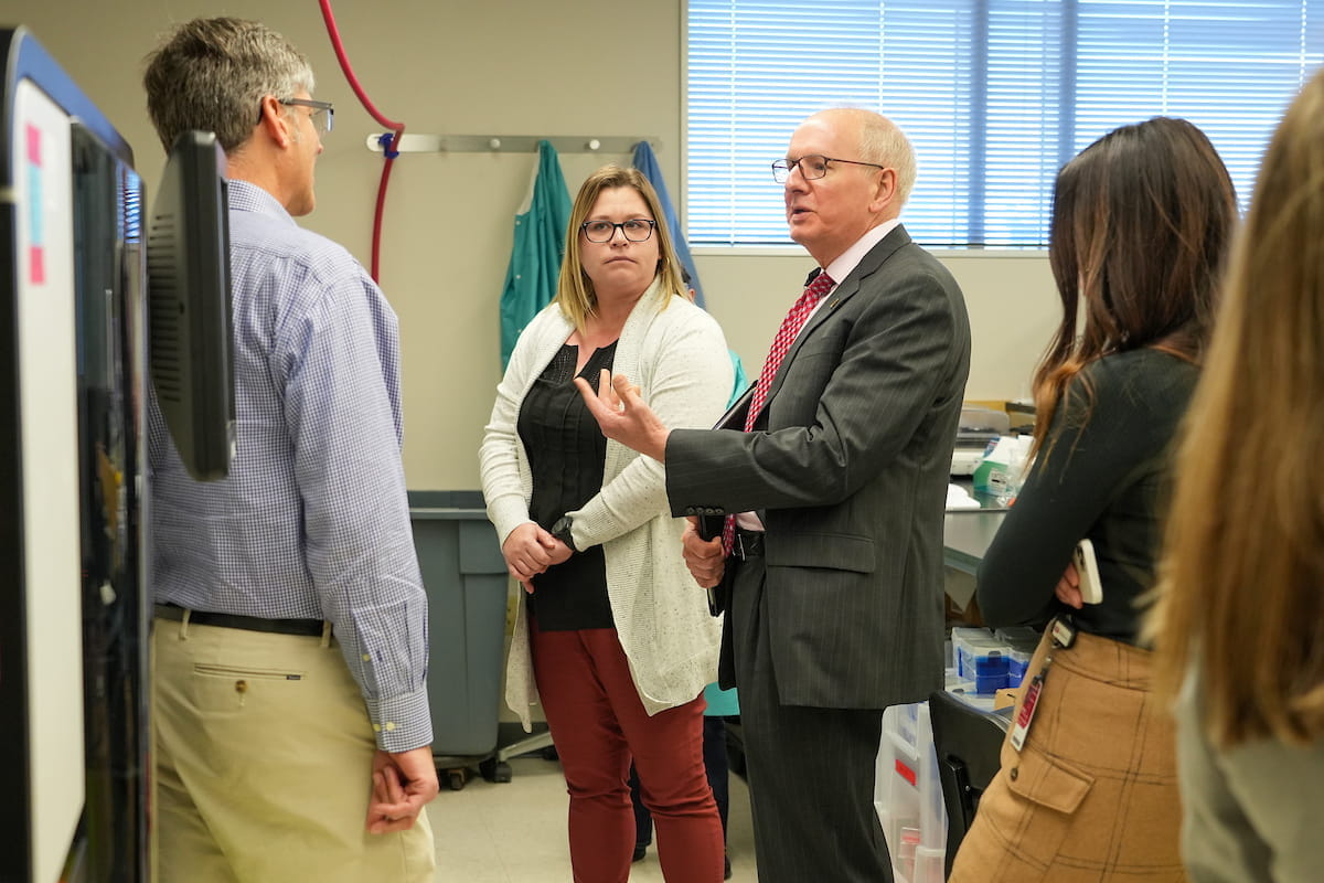 Dean Hess interacts with four faculty members during a lab tour