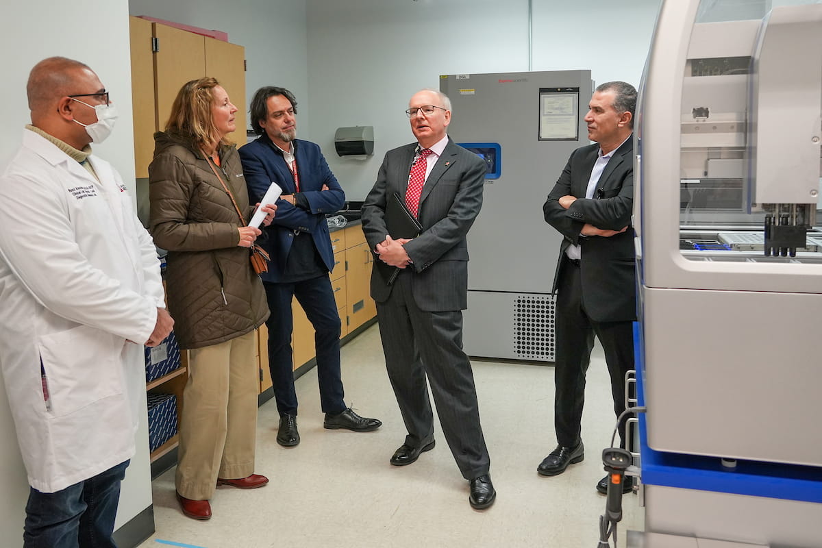 Dean Hess stands in a lab with four researchers