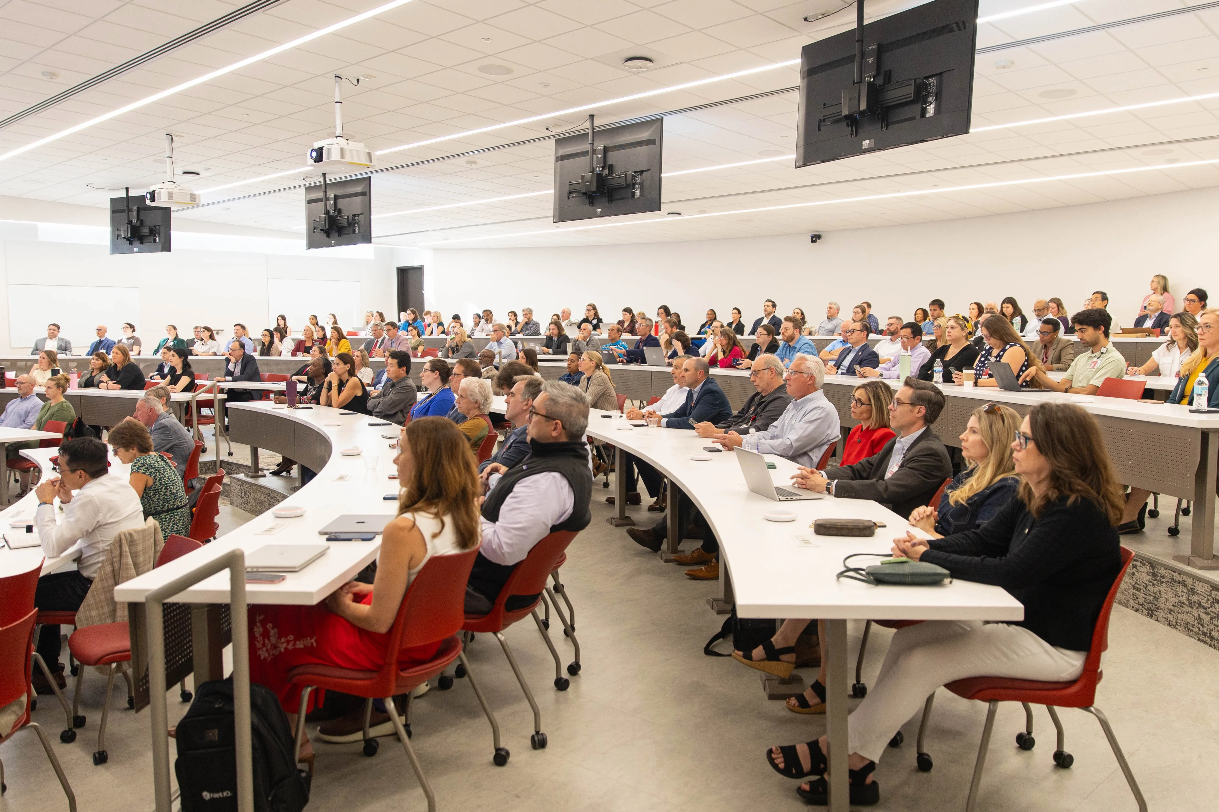 Faculty and staff fill the seats of a large classroom at the IU School of Medicine Medical Education and Research Building during the Fall All School Meeting.