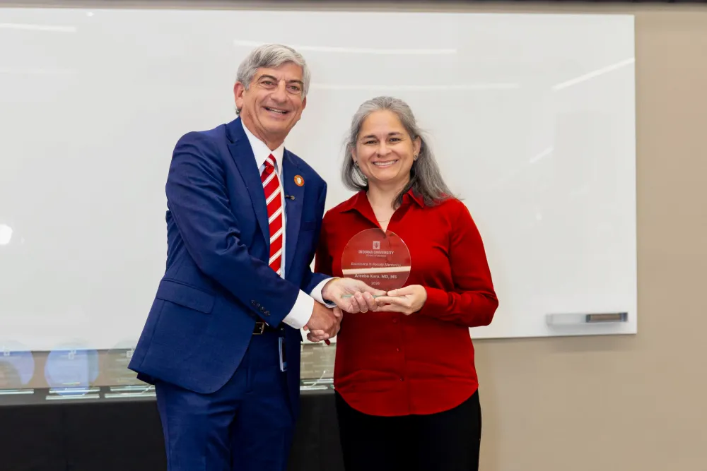 Dean Scott Boden poses with Areeba Kara as she holds her award.