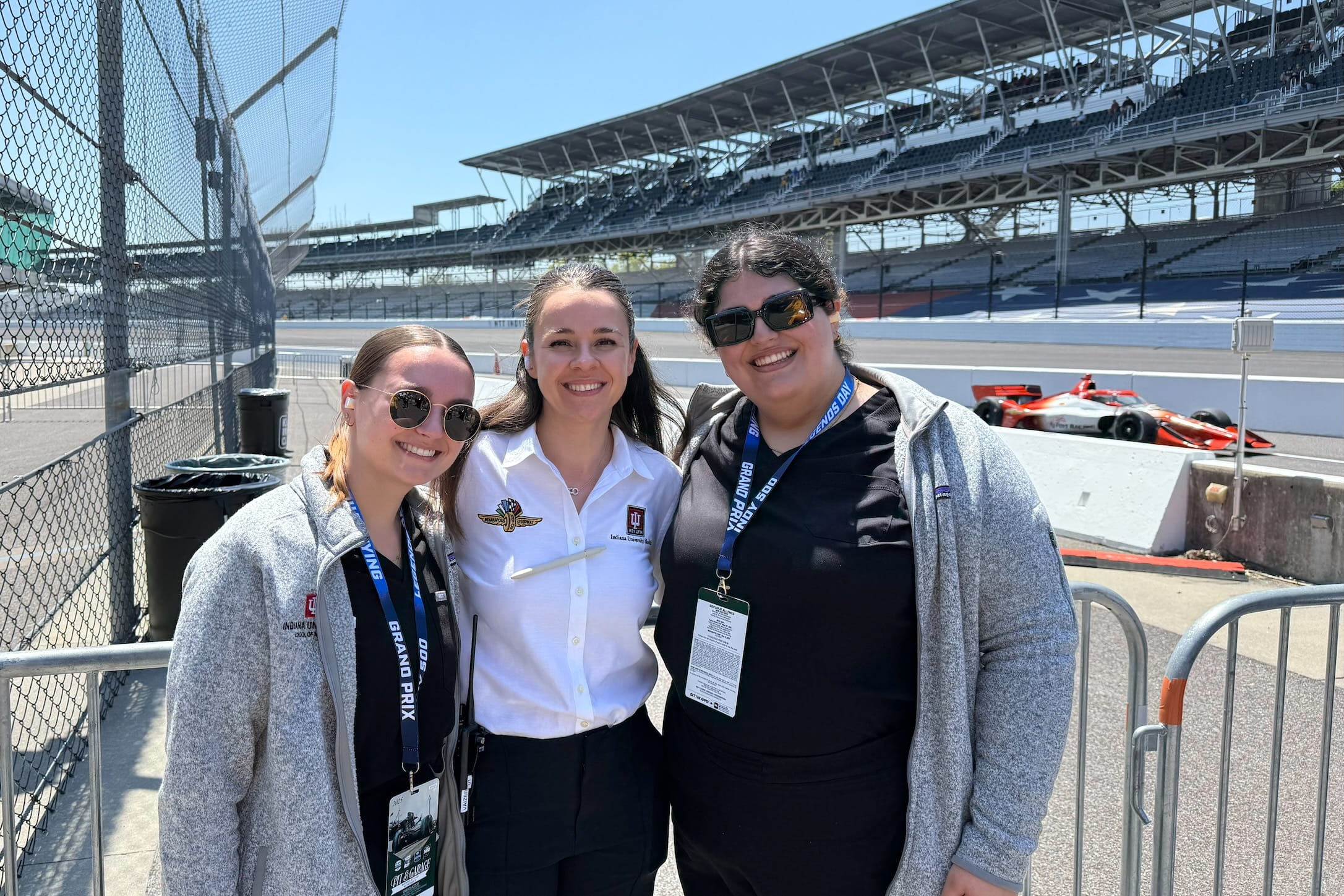 Julia Vaizer stands between two medical students at the Indianapolis Motor Speedway