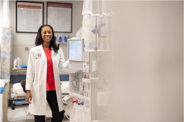 Marciana Laster standing in a hospital clinic wearing white coat