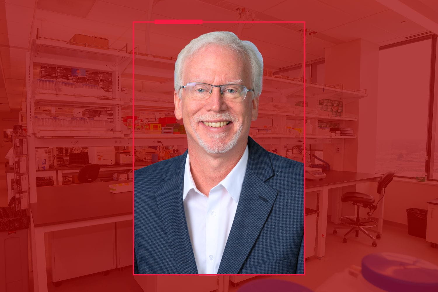 A man in glasses poses for a photo