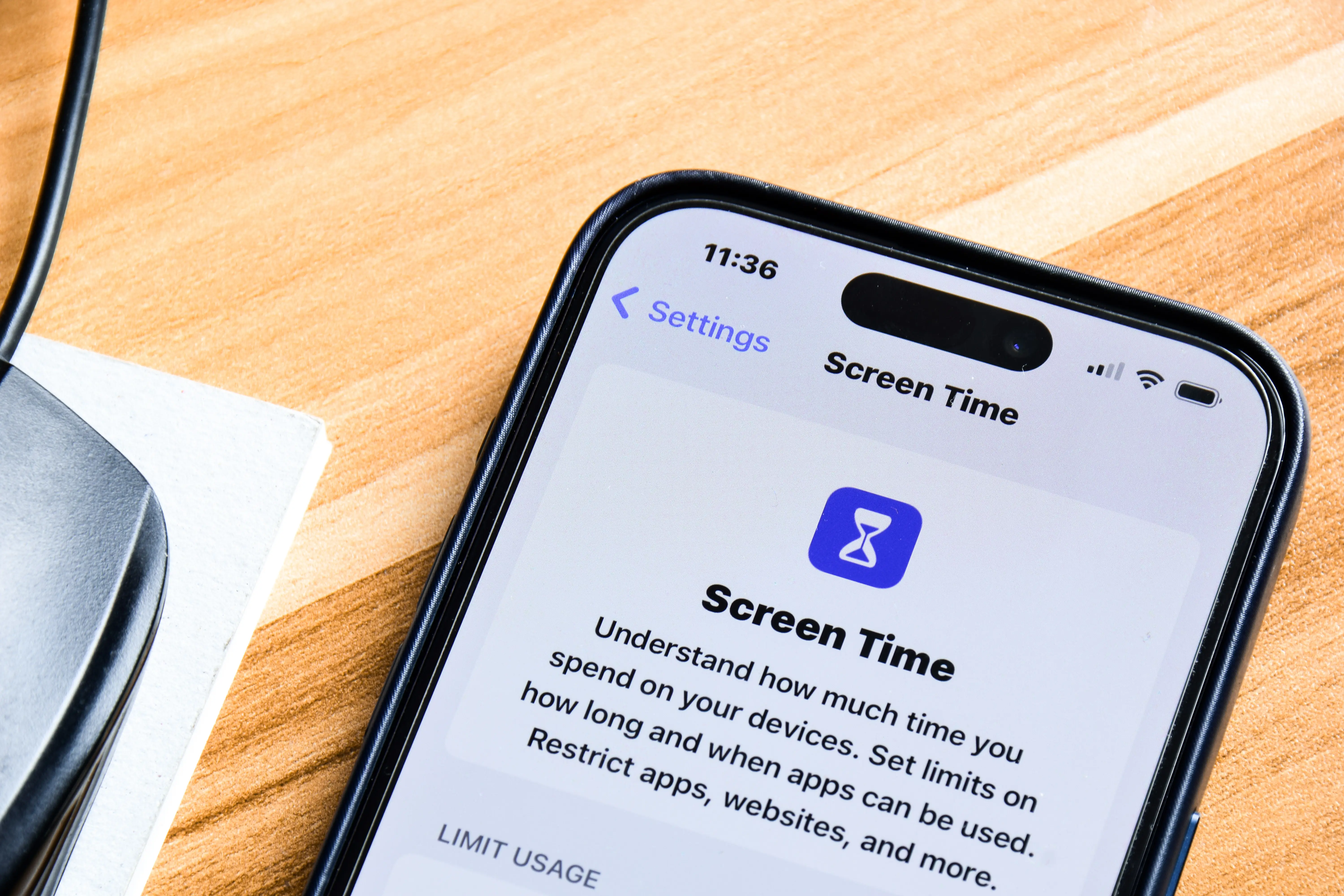 cell phone with a screen time management app shown on the screen