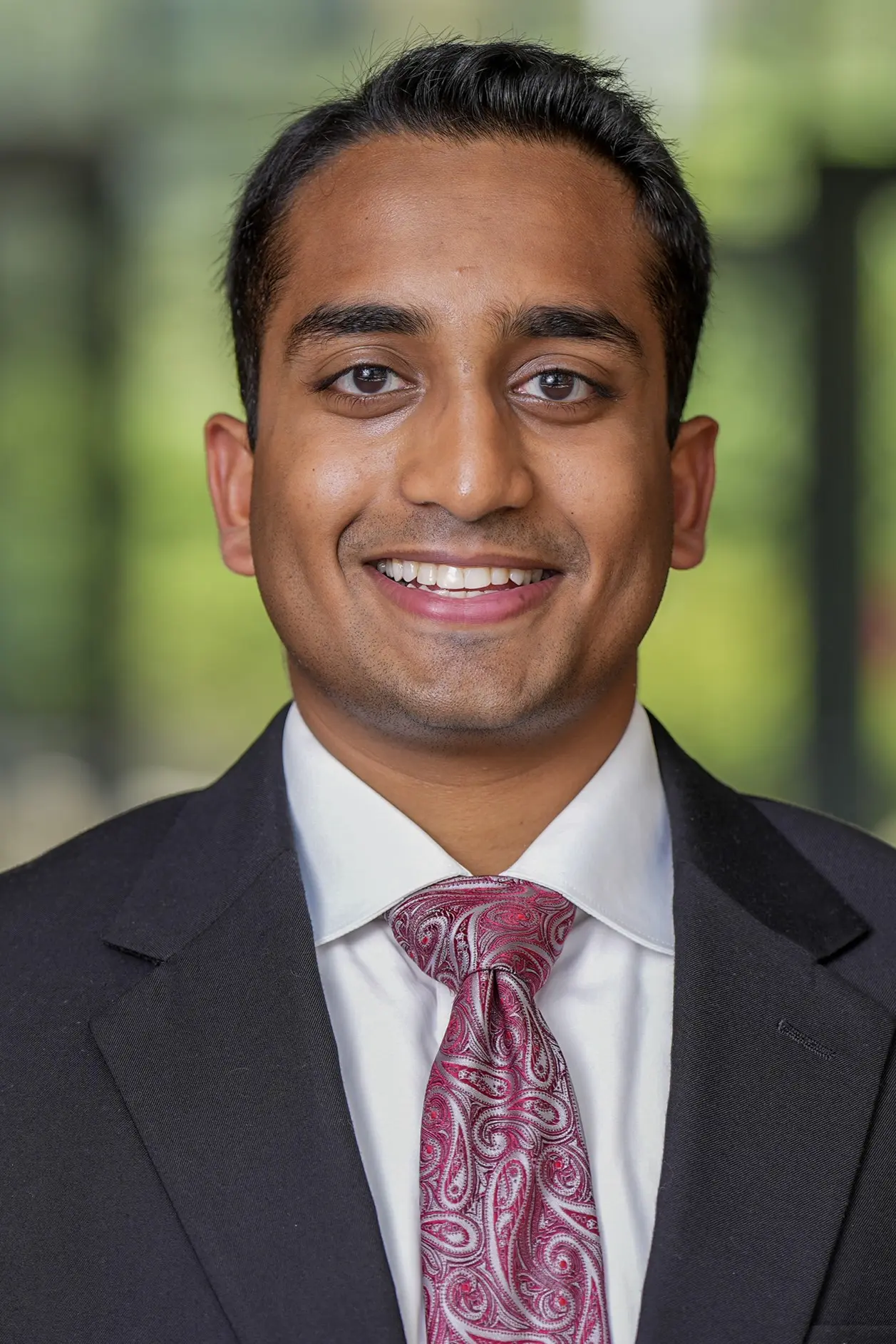 Person in professional attire with office lobby blurred background