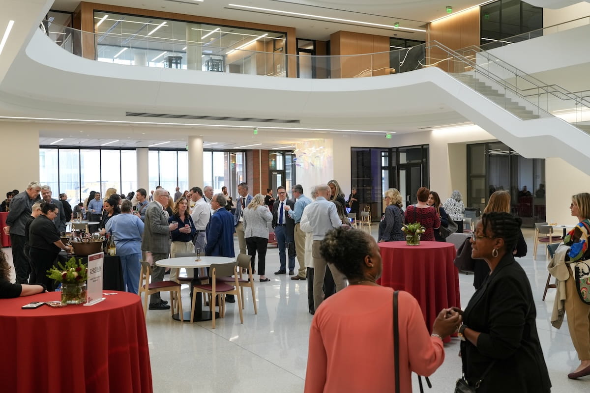 Attendees mingle at a reception in the Medical Education and Research Building atrium