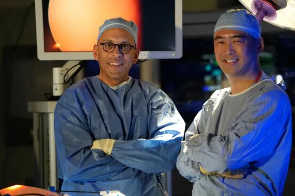 Karl Bilimoria and Anthony Yang pose for a photo in the operating room. | Photo courtesy Cassie Needy