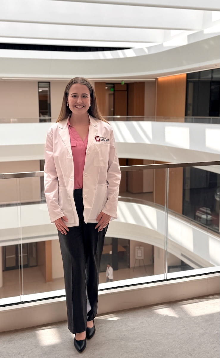 Sydney Clements wears her white coat in the Medical Education and Research Building