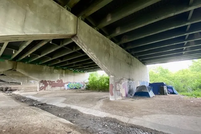 Two tents sit beneath an overpass in downtown Indianapolis.