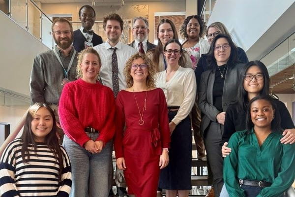 A group photo of surgery faculty on a staircase.
