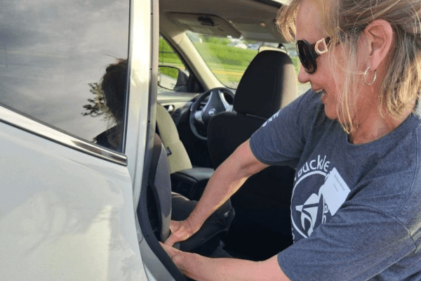 Volunteer installing a new car seat