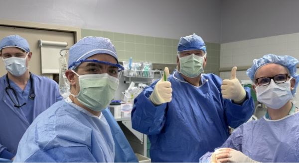 Wooden pictured in the operating room alongside his surgical team. | Photo courtesy William Wooden