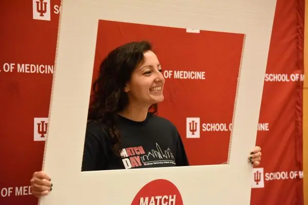 student holding match day sign