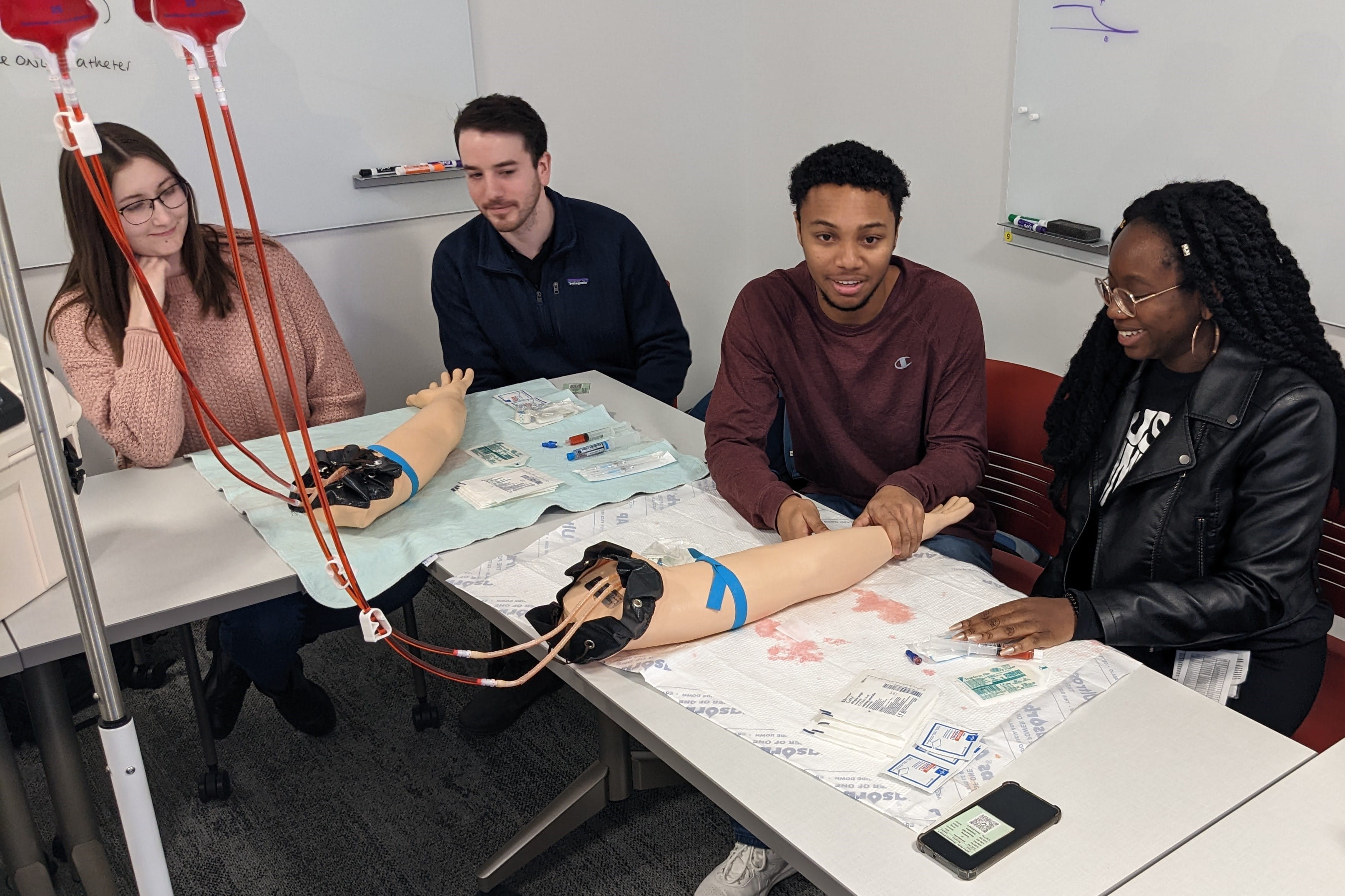 students practice inserting an IV line in the sim lab