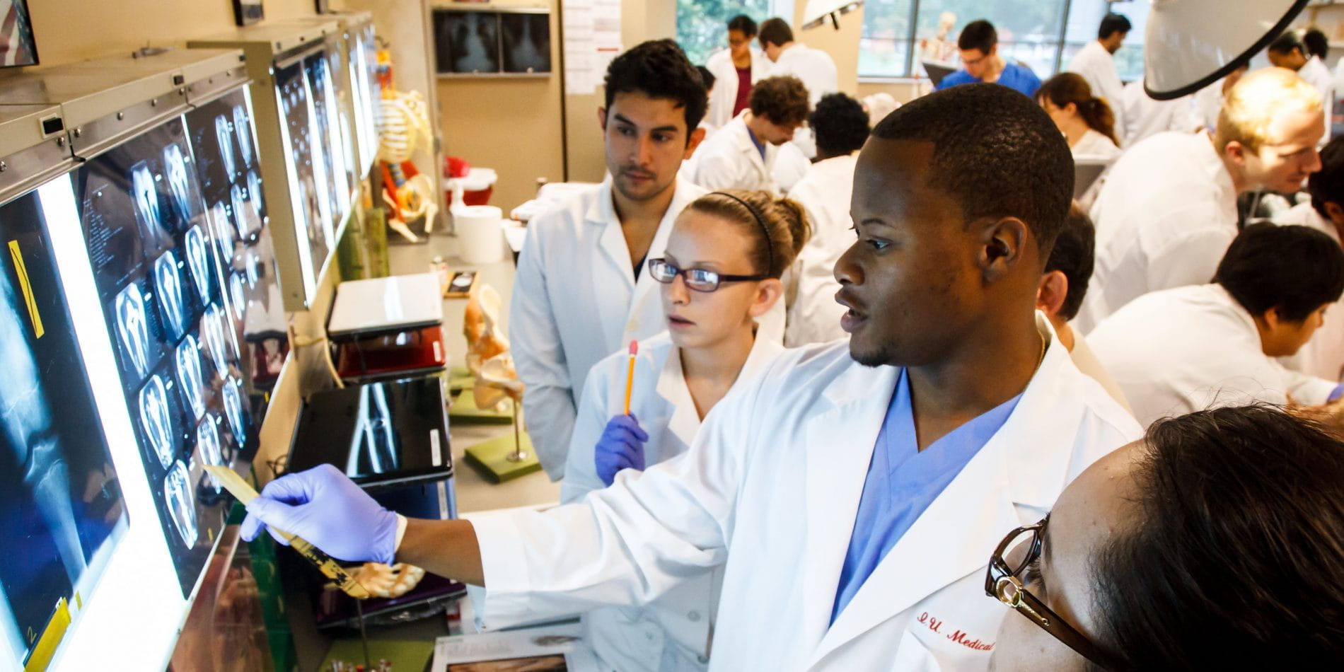 students work together to review imaging scans in Gary