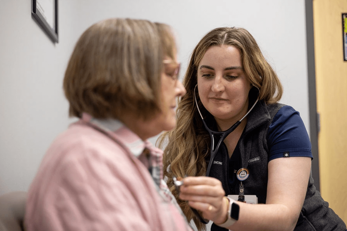An IU medical student listens to a patient's chest with a stethoscope.