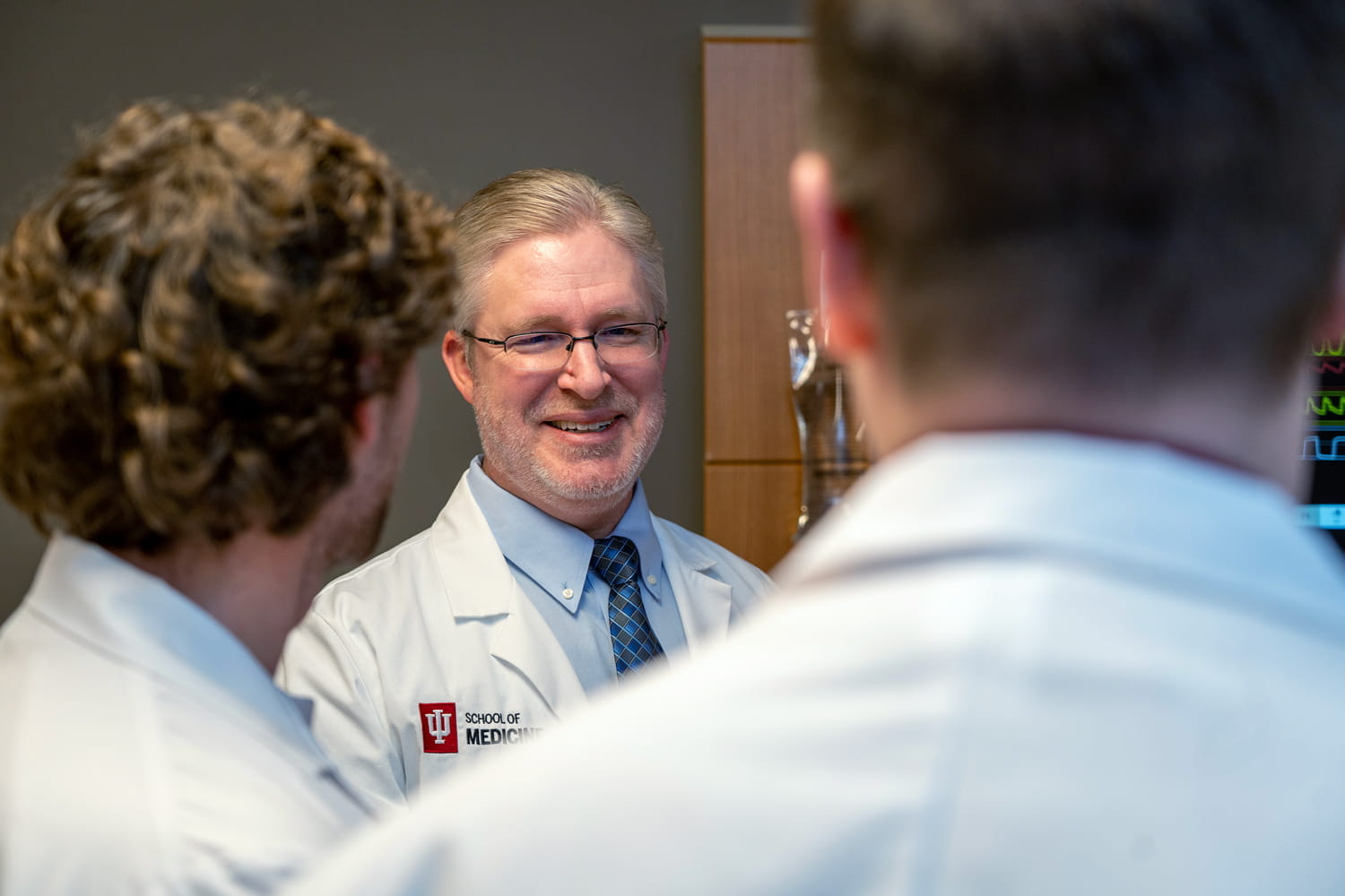 matthew tews speaks with two medical students