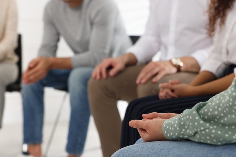 a group of diverse people sit together in a circle