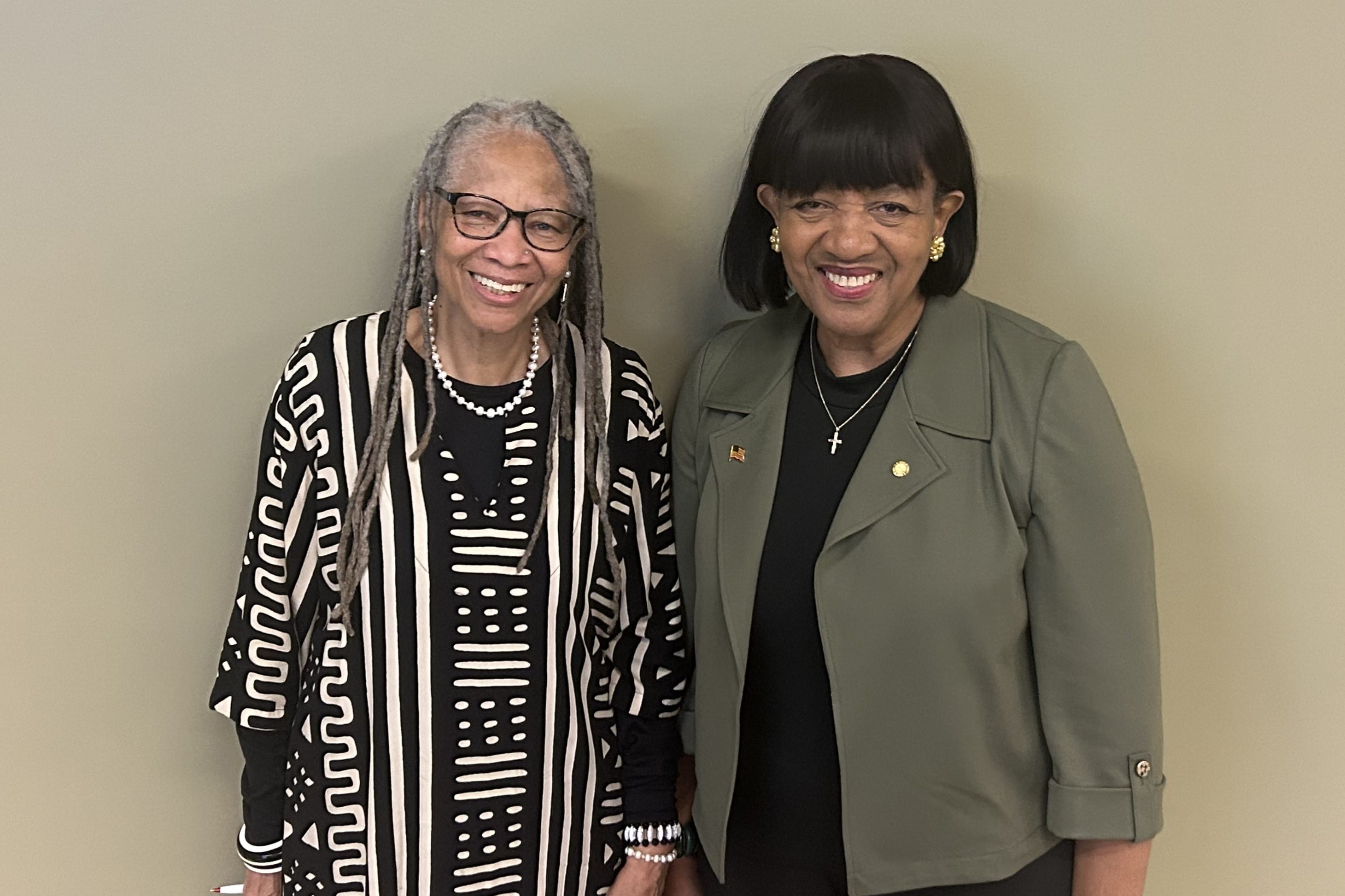 Two African-American women stand together for a photo.