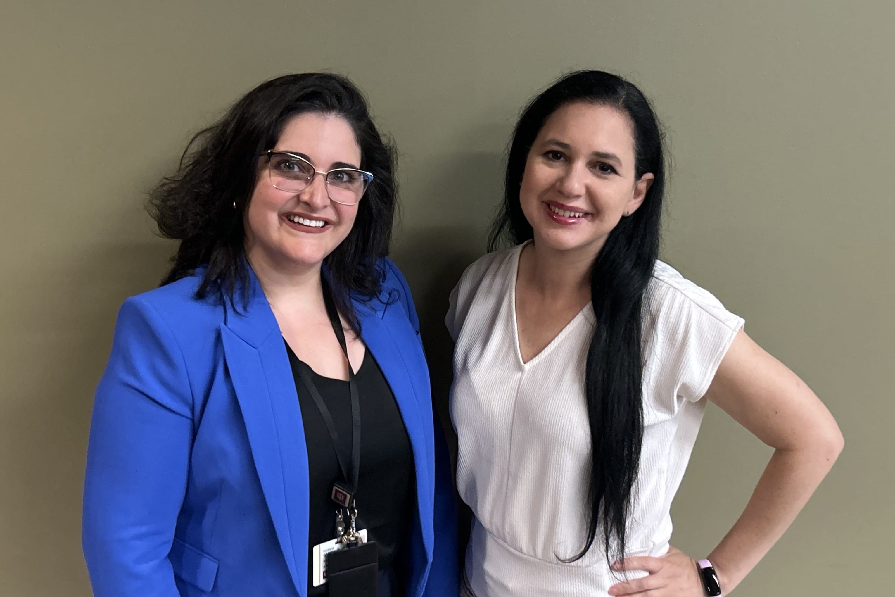 Two hispanic community advisory board members pose together for a photo.