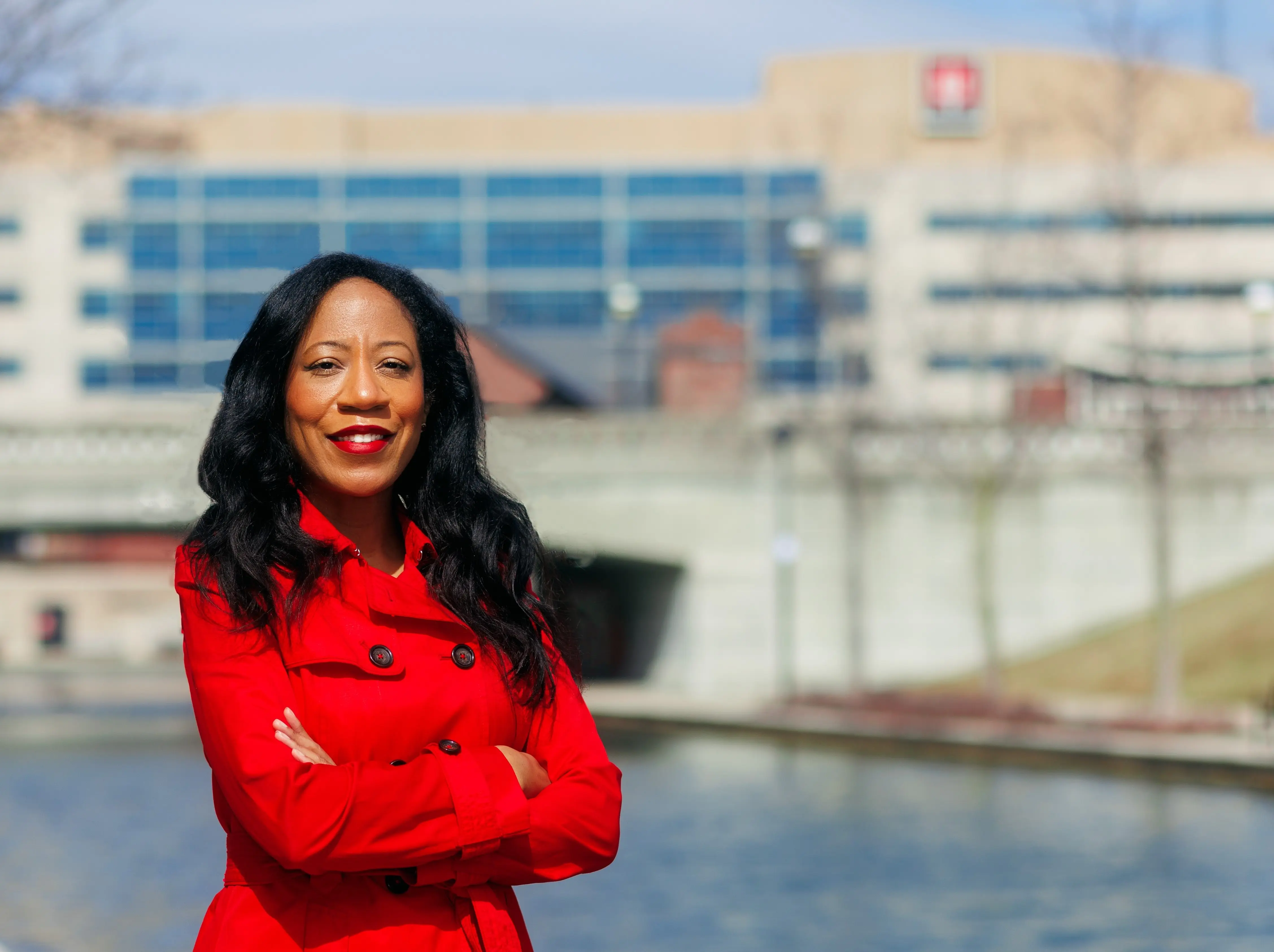 Khadijah Breathett, MD is photographed along the canal, with IU Health building in the background.