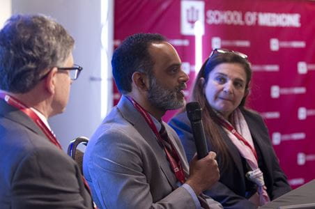 Edward Fry, MD, Sunil Rao, MD and Roxana Mehran, MD speak into a microphone