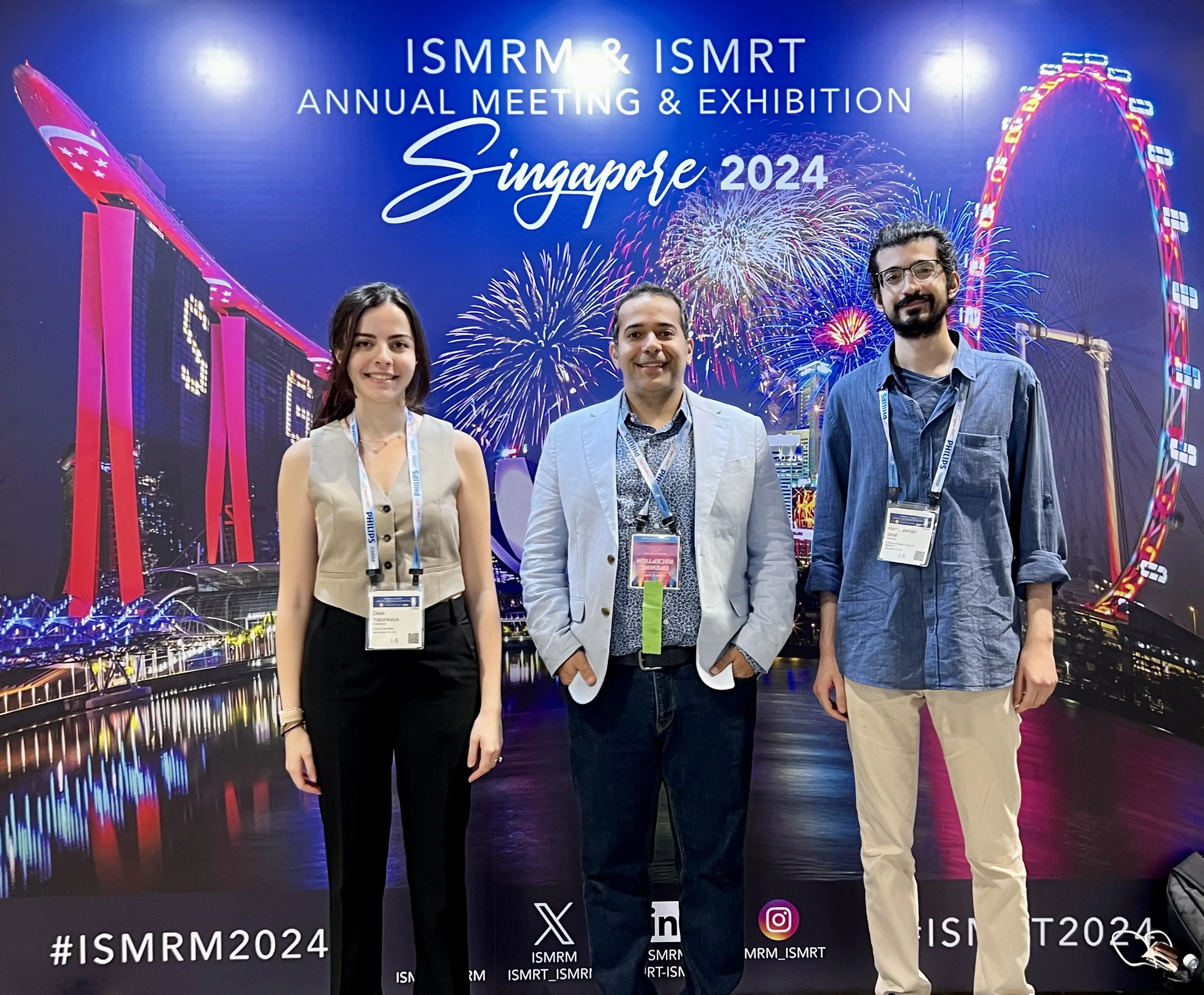 Dilek M. Yalcinkaya, MS, Behzad Sharif, PhD, and Hazar Benan Unal, MS, traveled to Singapore to present at the 2024 ISMRM & ISMRT Annual Meeting. Yalcinkaya and Unal are Purdue University doctoral candidates that are also IU Krannert research trainees. They are pictured in front of a conference poster backdrop with fireworks and a ferris wheel.