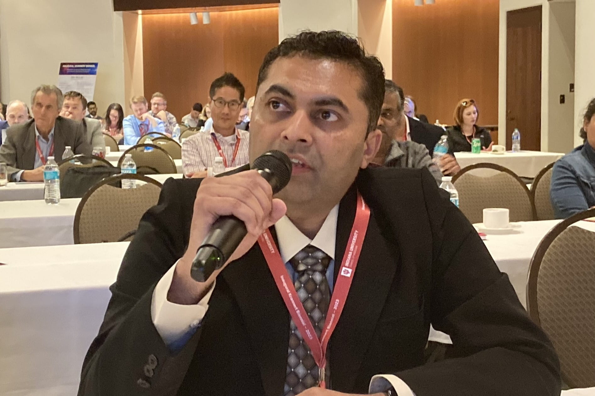 keyur voya asks a question holding a microphone