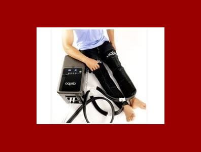 Illustration shows figure using heat therapy system comprised of water circulating trousers and water pump.