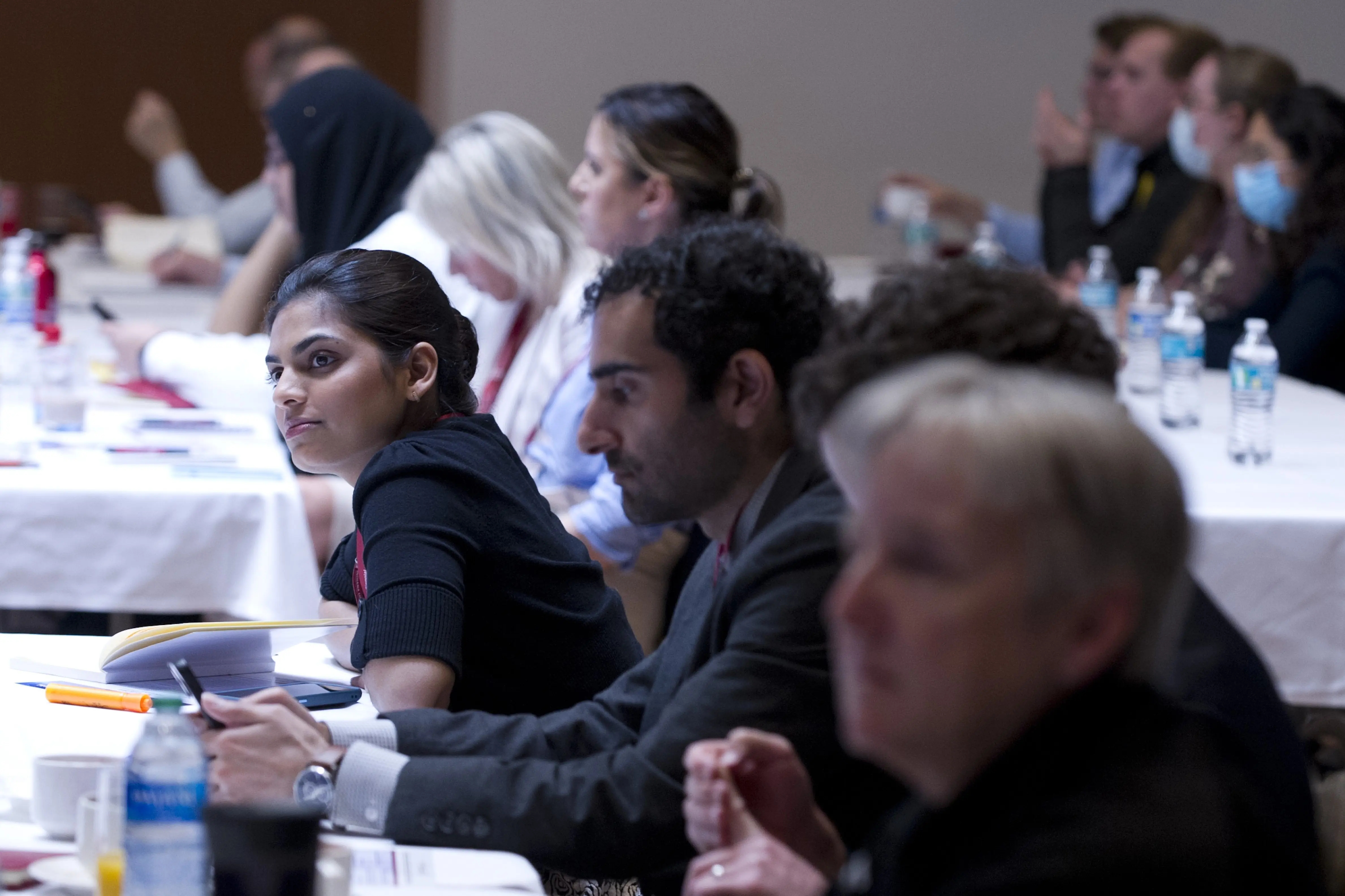 audience members eagerly listen to a speaker