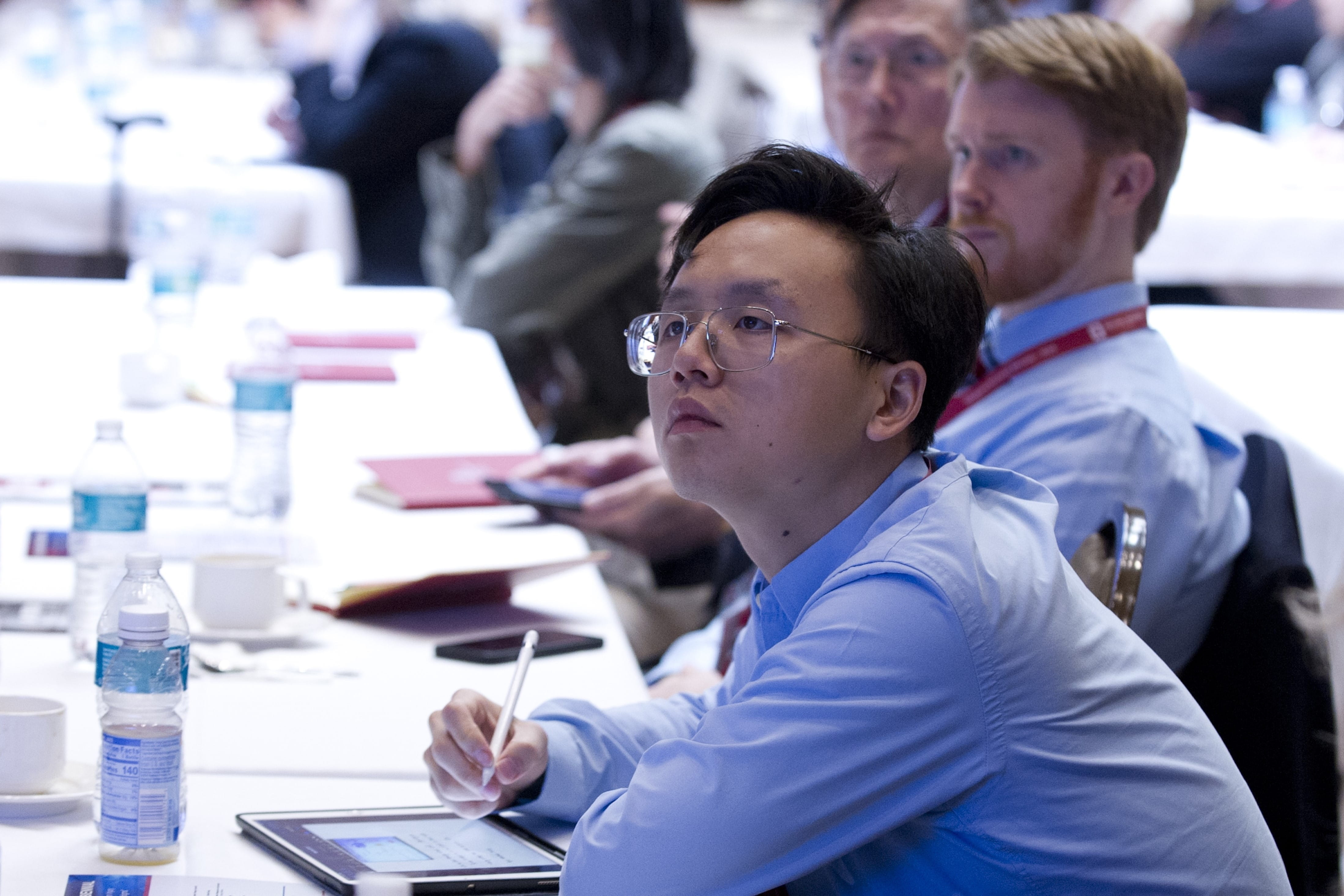 a phd student takes notes during the conference
