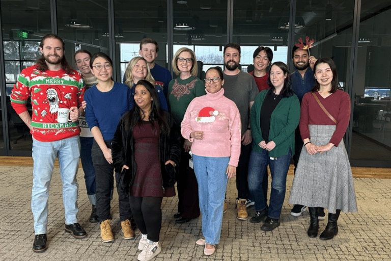 Group of 13 personnel from the Evans-Molina lab posing for a holiday photo