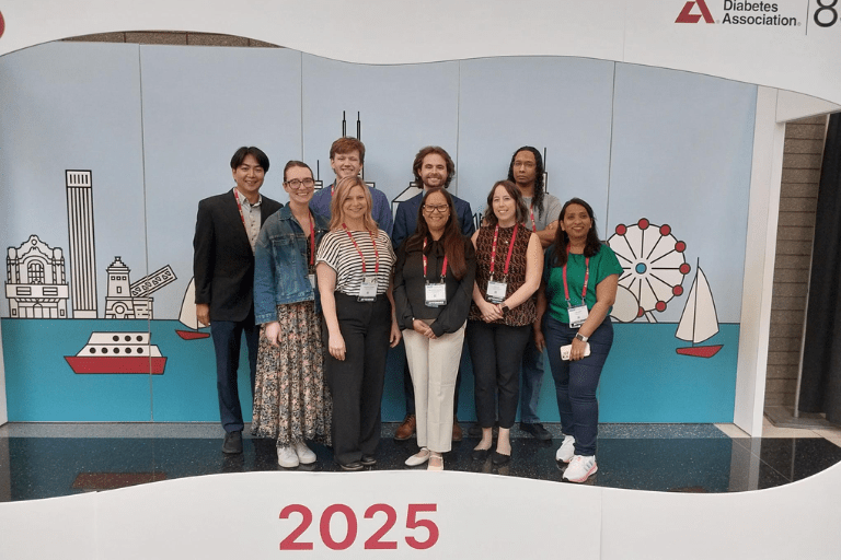 Group photo of 9 personnel from the Evans-Molina lab at an ADA event in 2025