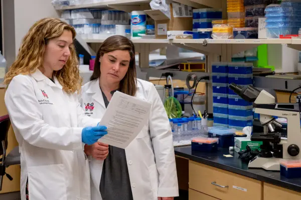Dr. Emily Sims and Dr. Jamie Felton in a lab