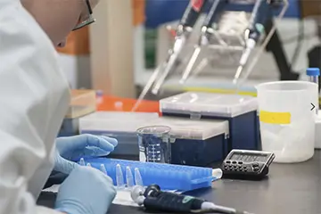 Lab member working at a lab bench