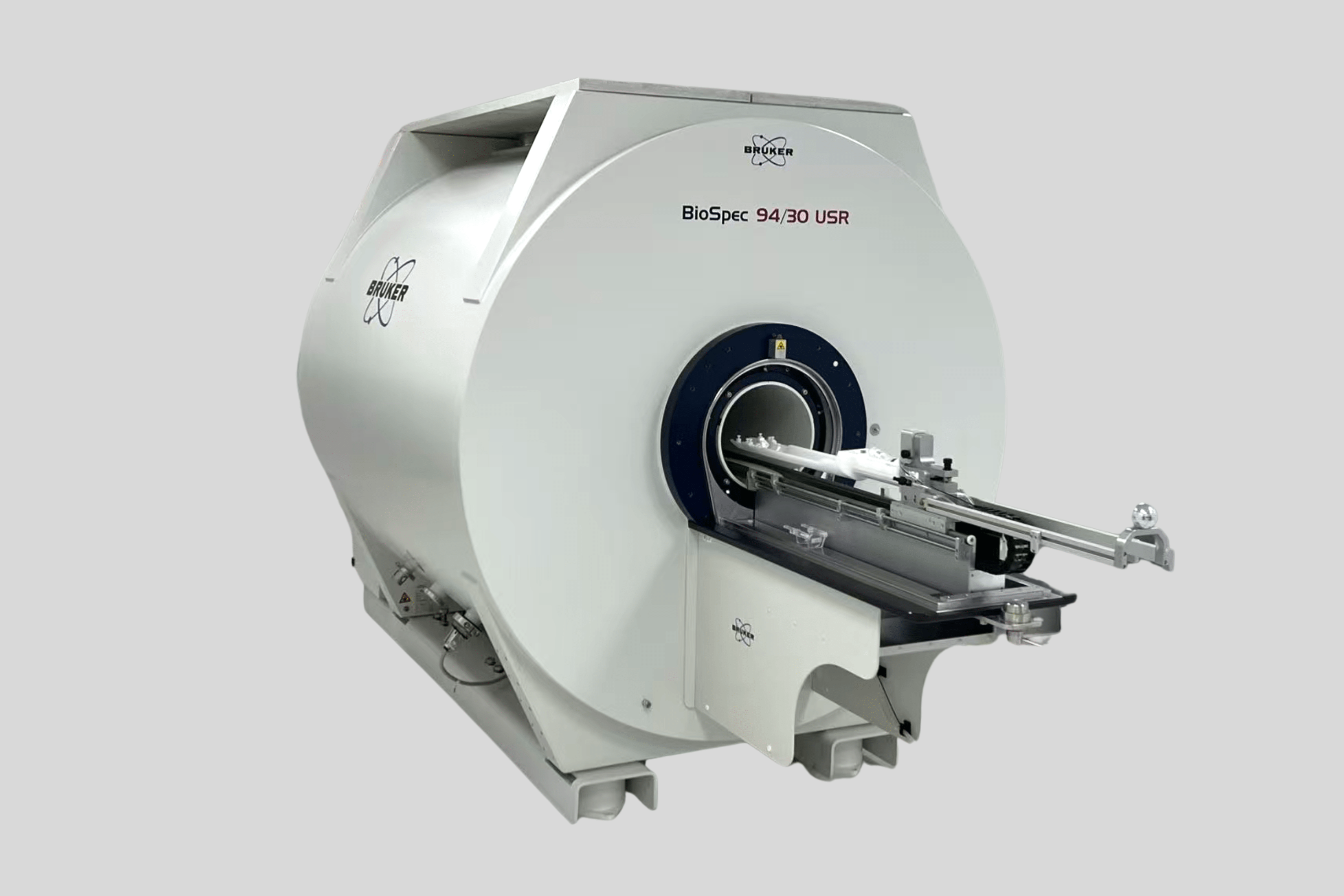 Vector image of the Bruker BioSpec 94/30 MR Scanner with gradient inserts, 1H MRI CryoProbeTM, and PET Insert Si 20/12 on a gray background.